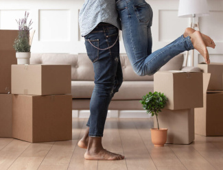 First-time buyers embracing after moving in to their new Galliard property