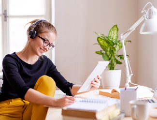 Woman listens to music while she works from home, Galliard Homes Woman listens to music while she works from home, Galliard Homes